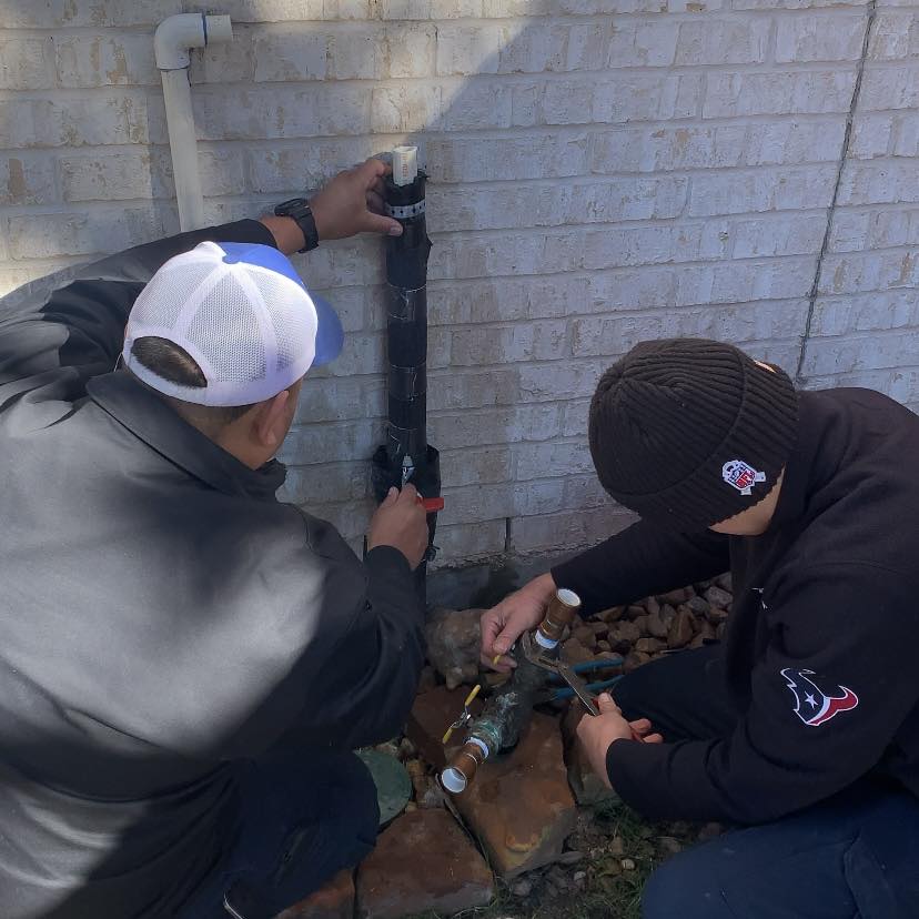 two technicians doing plumbing repair in houston tx