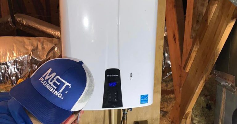 a MET Plumbing technician performing a tankless water heater installation in katy tx